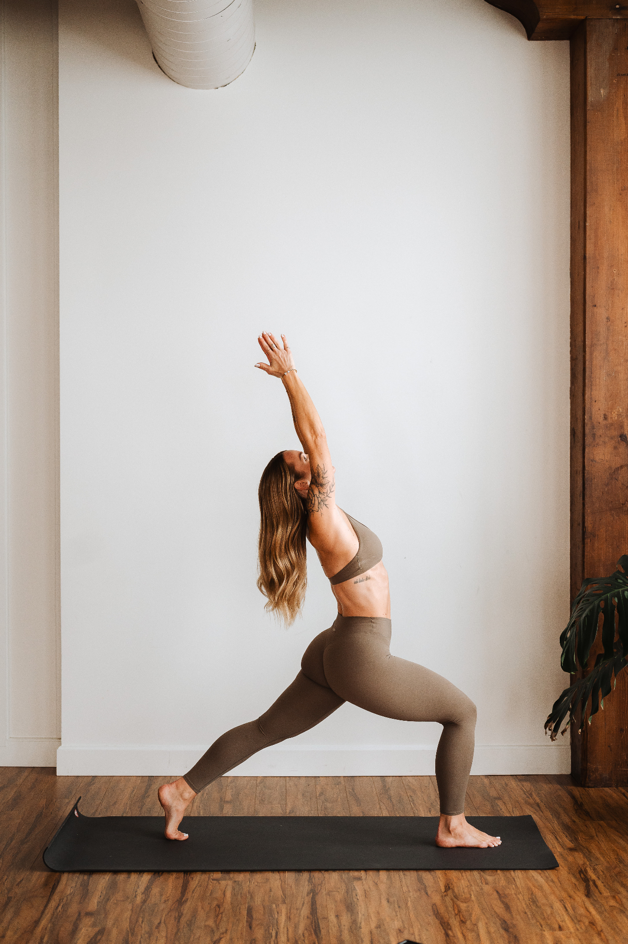 Kelli Blake in a crescent lunge with arms overhead