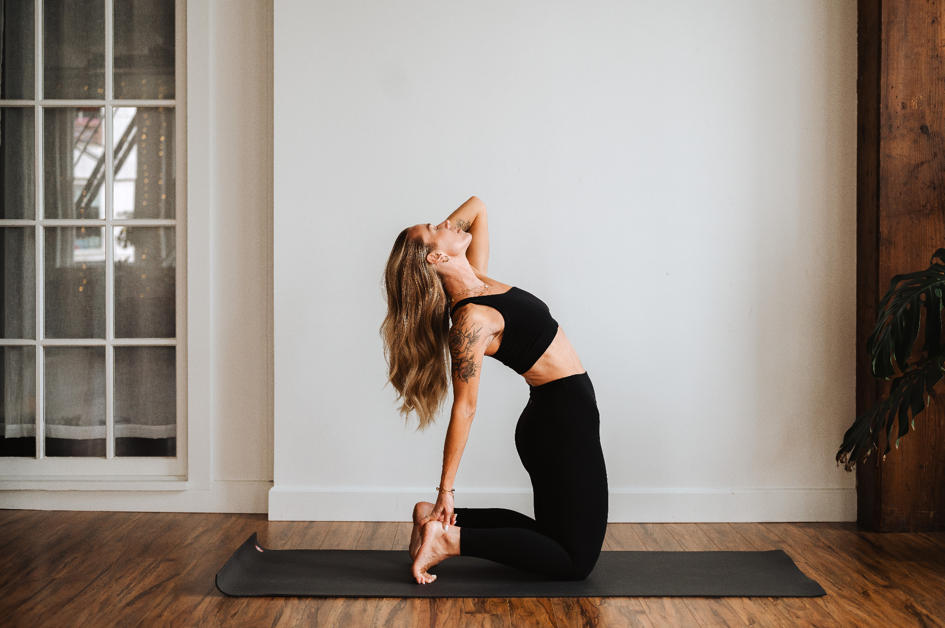 Kelli Blake in camel pose on the mat